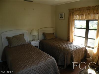 1287 Sand Castle Road Sanibel, FL 33957 - Photo 6 of 9 a bedroom with a bed and a window