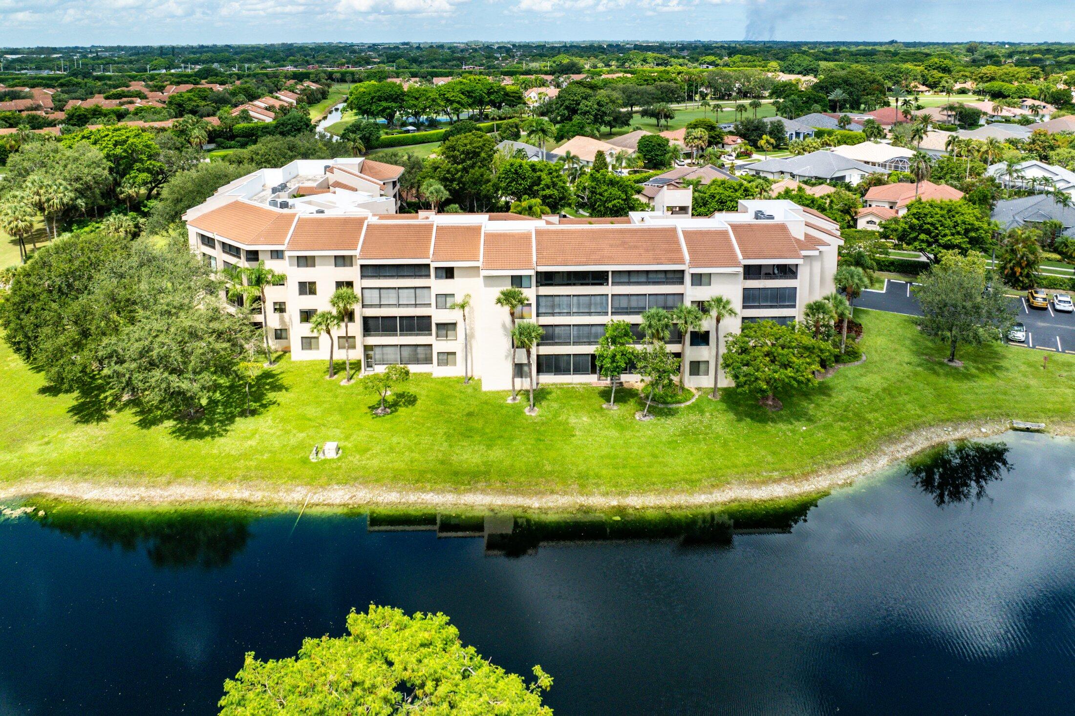 an aerial view of a house with a garden swimming pool and outdoor seating