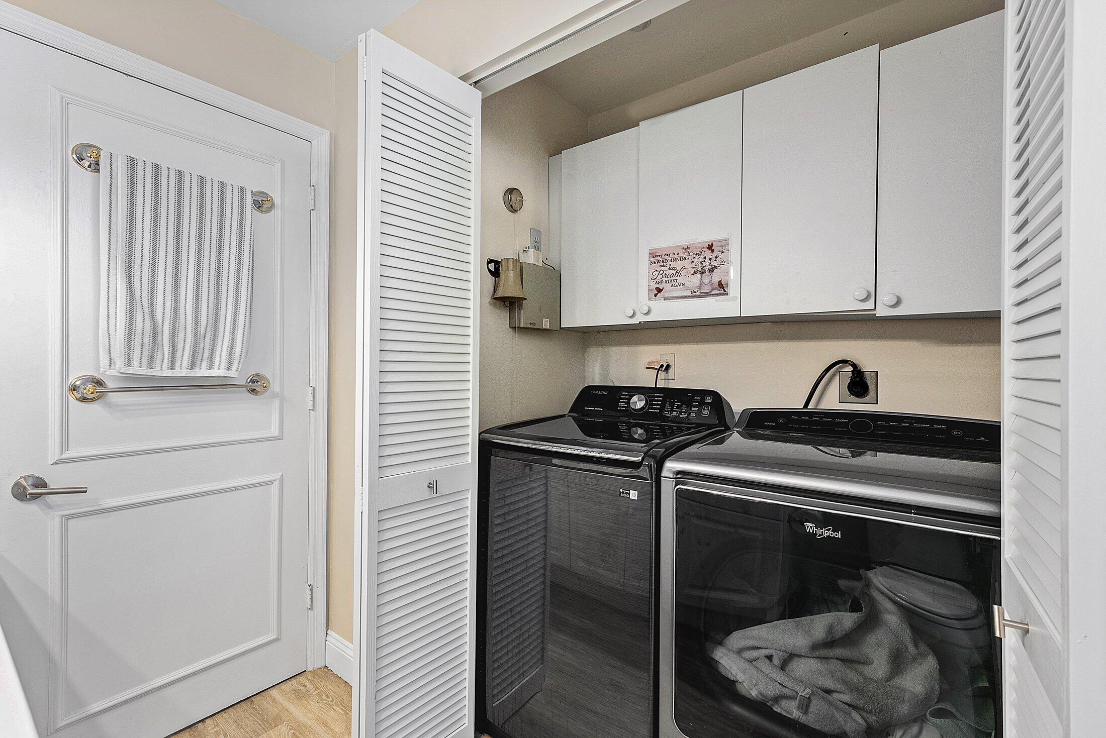 7546 La Paz Boulevard, Unit 404 Boca Raton, FL 33433 - Photo 28 of 47 a utility room with dryer and washer