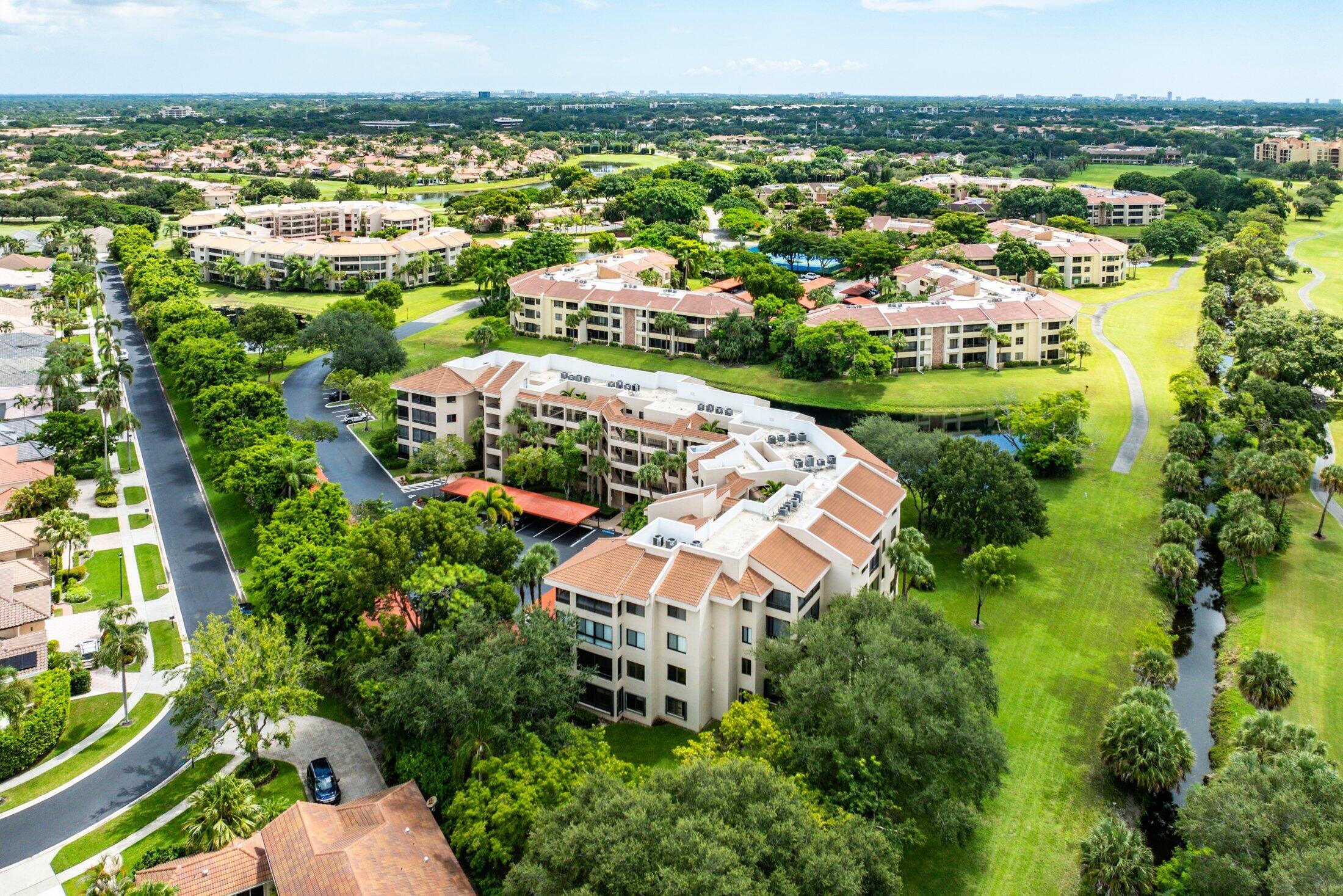 7546 La Paz Boulevard, Unit 404 Boca Raton, FL 33433 - Photo 31 of 47 an aerial view of residential houses with outdoor space and trees