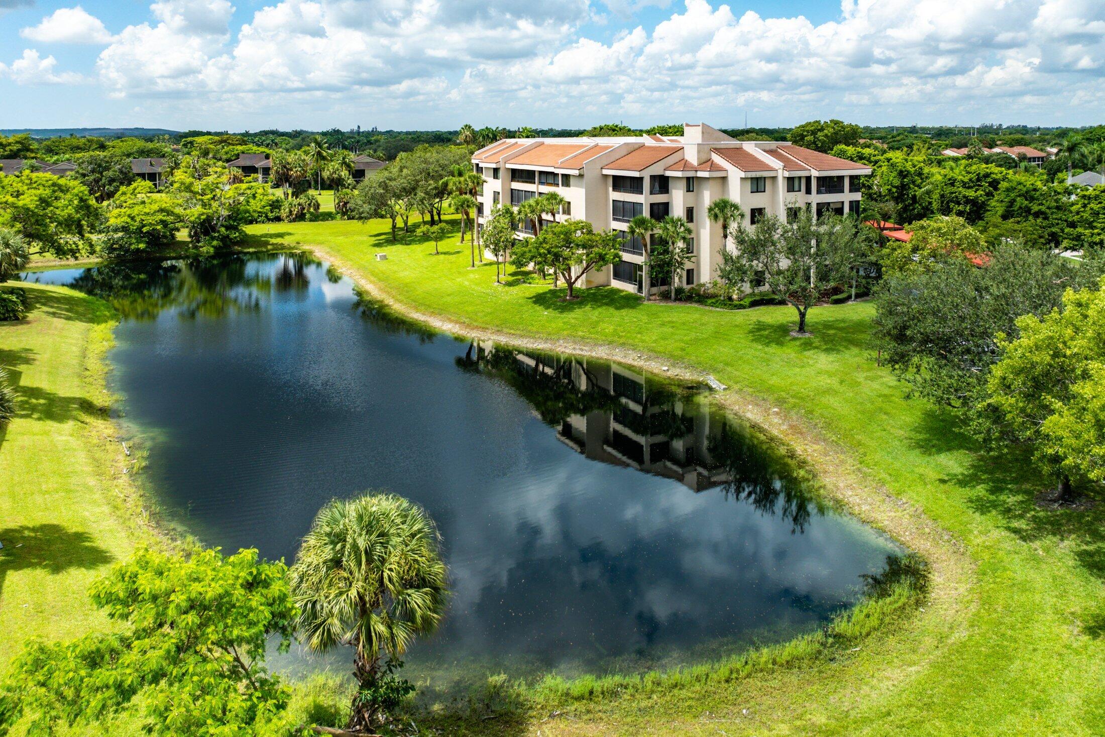 7546 La Paz Boulevard, Unit 404 Boca Raton, FL 33433 - Photo 34 of 47 a view of a lake with a building in the background