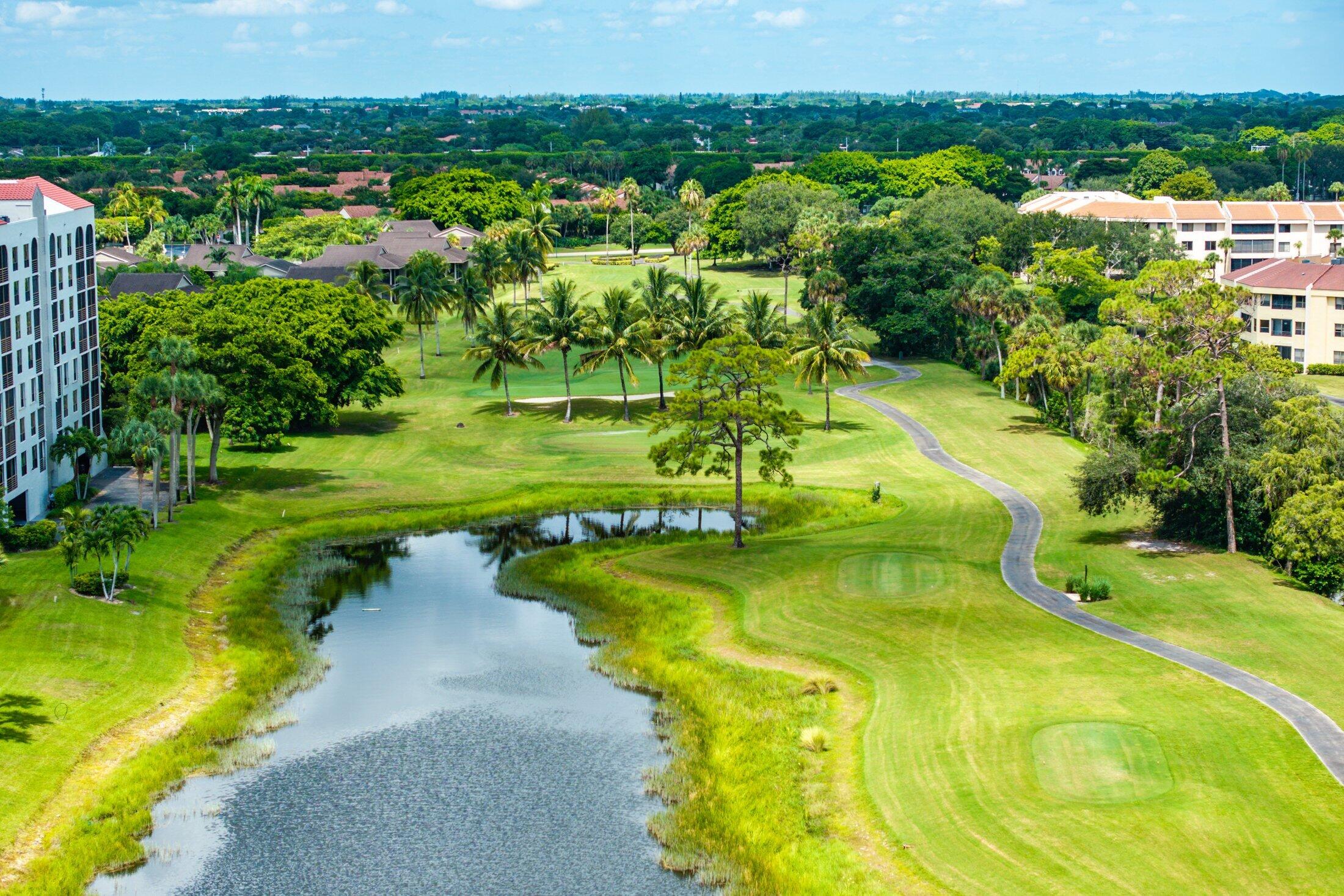 7546 La Paz Boulevard, Unit 404 Boca Raton, FL 33433 - Photo 35 of 47 a view of a swimming pool with a yard