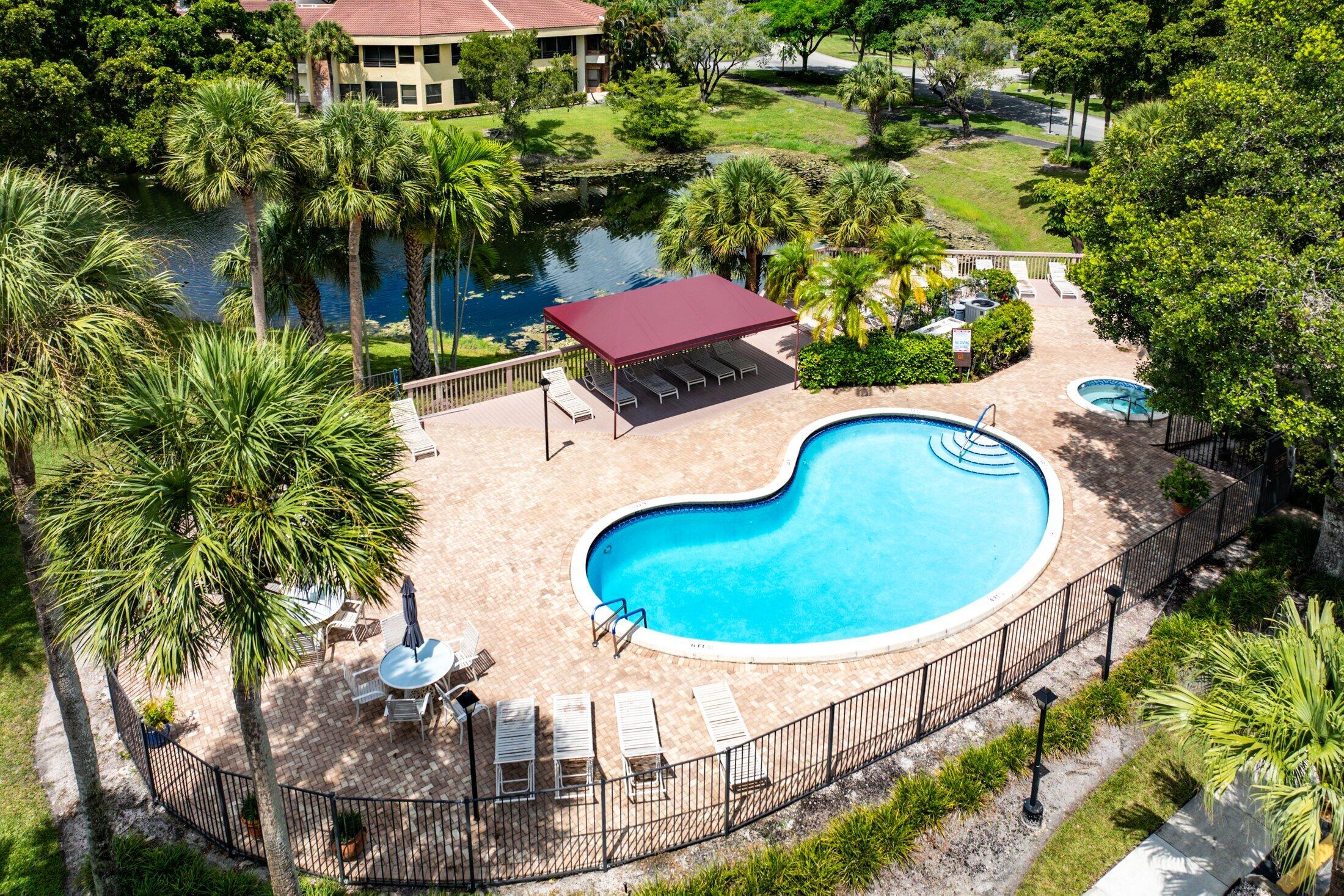 7546 La Paz Boulevard, Unit 404 Boca Raton, FL 33433 - Photo 36 of 47 an aerial view of a house with swimming pool and garden