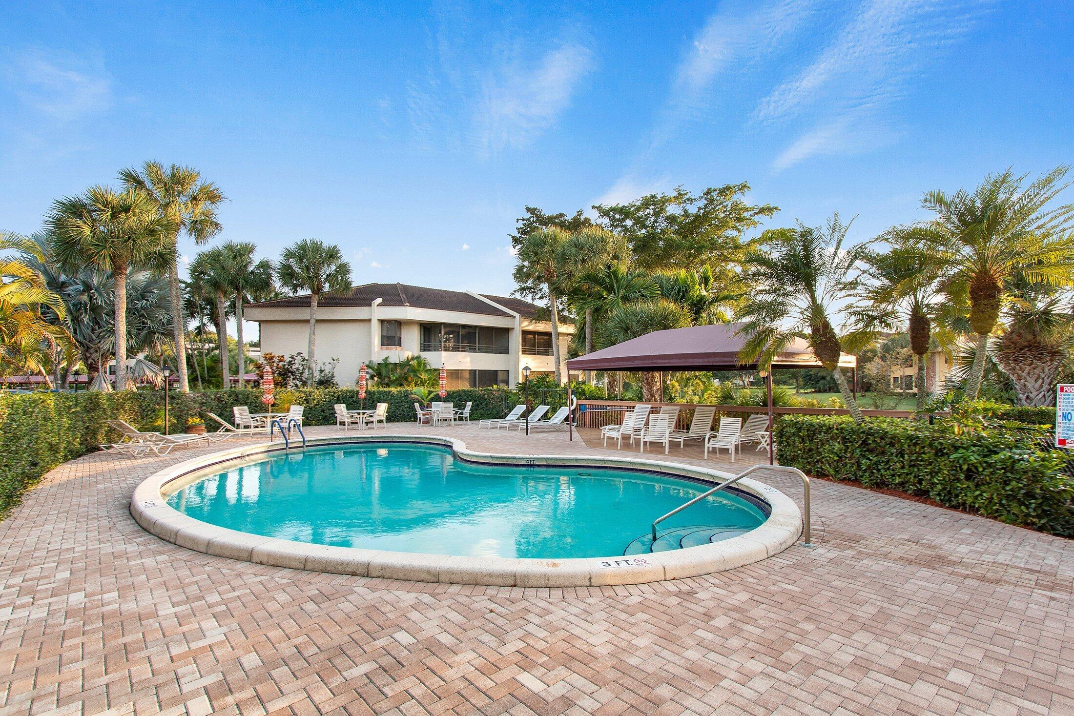 7546 La Paz Boulevard, Unit 404 Boca Raton, FL 33433 - Photo 44 of 47 a view of a swimming pool with a yard