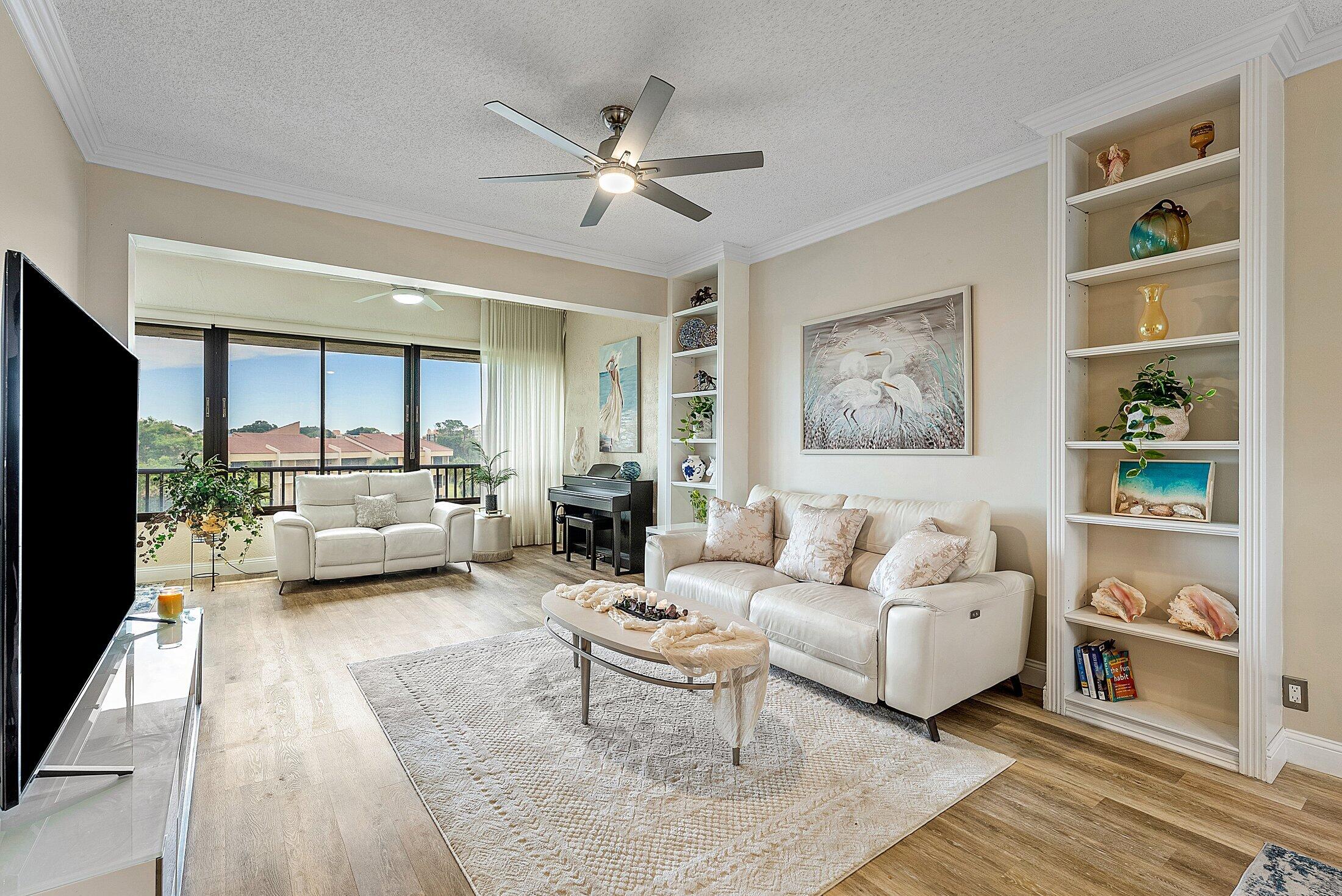 7546 La Paz Boulevard, Unit 404 Boca Raton, FL 33433 - Photo 5 of 47 a living room with furniture and a large window