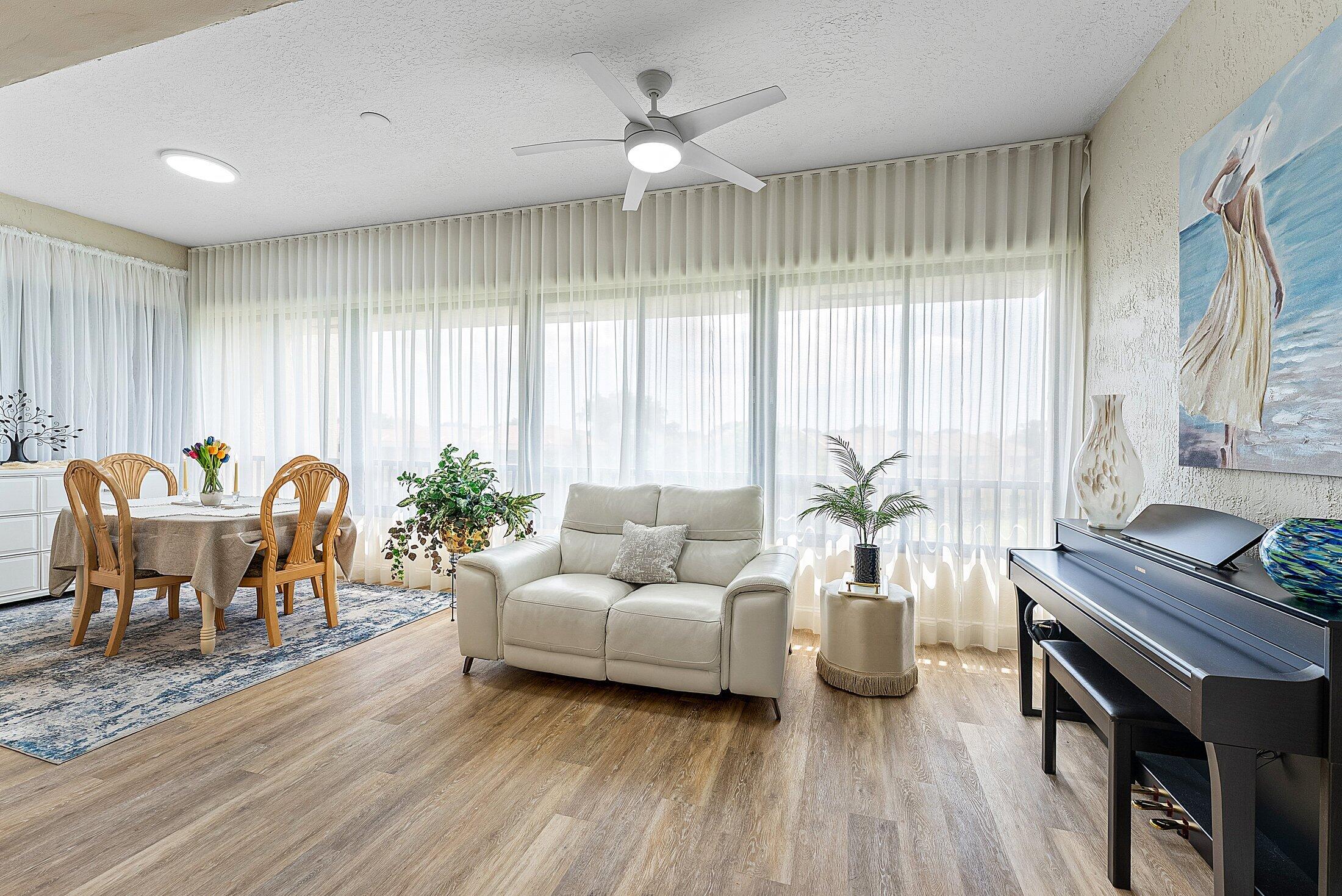 7546 La Paz Boulevard, Unit 404 Boca Raton, FL 33433 - Photo 9 of 47 a living room with furniture and wooden floor