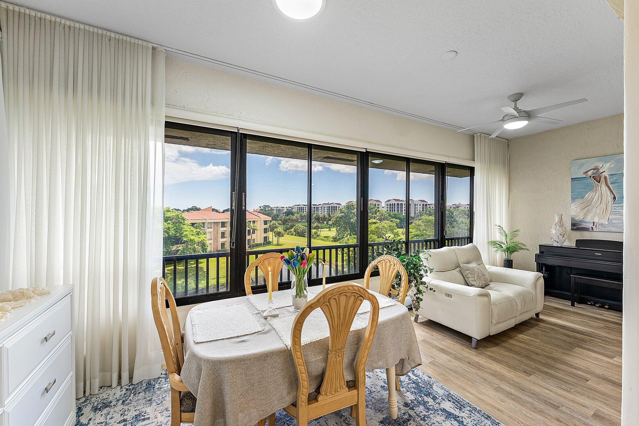 7546 La Paz Boulevard, Unit 404 Boca Raton, FL 33433 - Photo 10 of 47 a living room with furniture and a large window