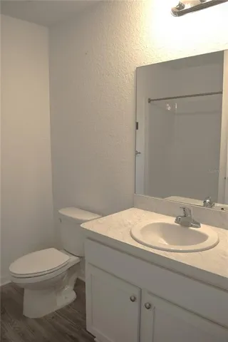 a bathroom with a sink a toilet and mirror