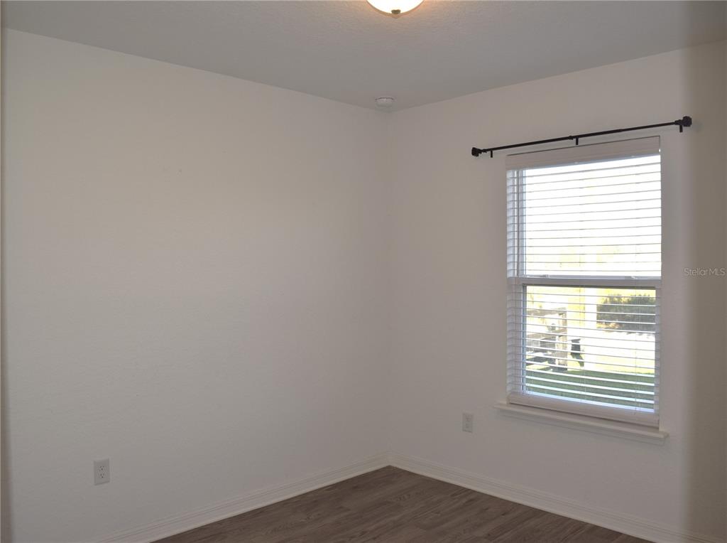 3184 Southwest 151st Avenue Ocala, FL 34481 - Photo 12 of 17 a view of an empty room with wooden floor and a window