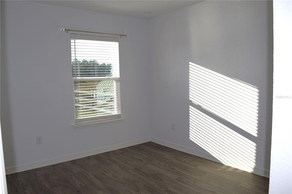 3184 Southwest 151st Avenue Ocala, FL 34481 - Photo 13 of 17 an empty room with wooden floor and a window