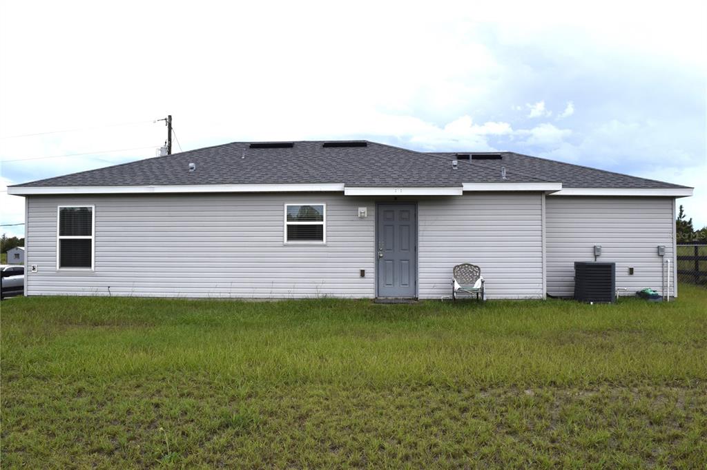 3184 Southwest 151st Avenue Ocala, FL 34481 - Photo 4 of 17 a backyard of a house with table and chairs