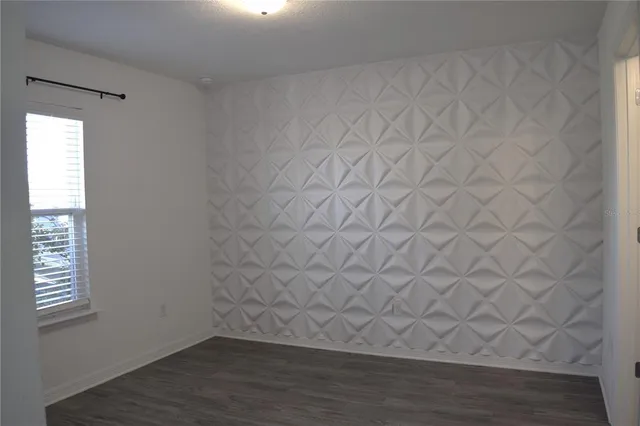a view of an empty room and wooden floor in a room
