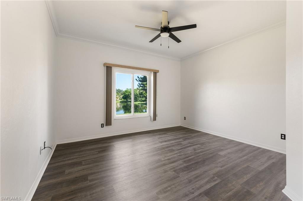 223 Stanhope Circle Naples, FL 34104 - Photo 16 of 41 Spacious room featuring wood-finish flooring, crisp white walls, and a contemporary ceiling fan