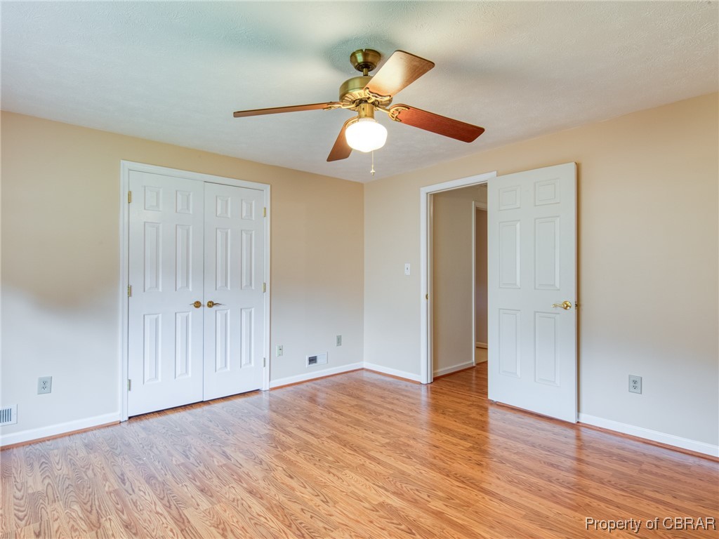 6 Ruth Circle Hampton, VA 23666 - Photo 32 of 50 Unfurnished bedroom featuring ceiling fan, light wood-type flooring, and a closet