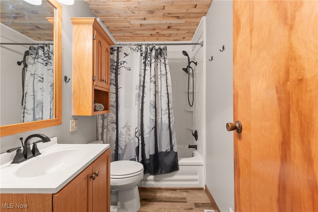 14808 Wheeler Road Lagrange, OH 44050 - Photo 31 of 50 Bathroom with shower / bathtub combination with curtain, light wood-style floors, vanity, and wood ceiling