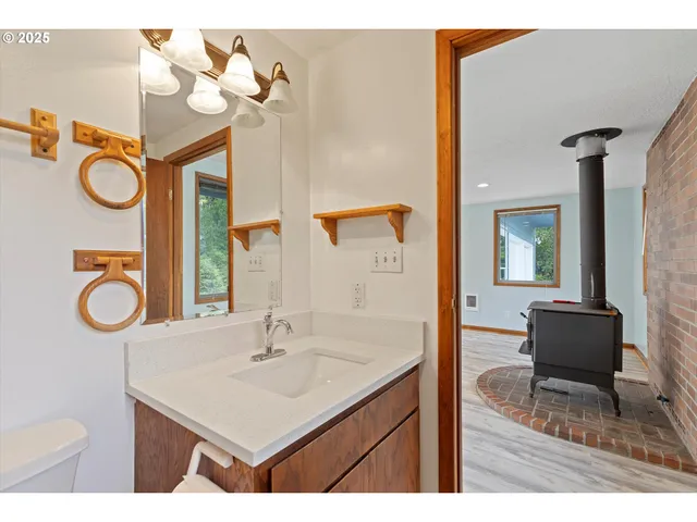 a bathroom with a sink a mirror and a toilet