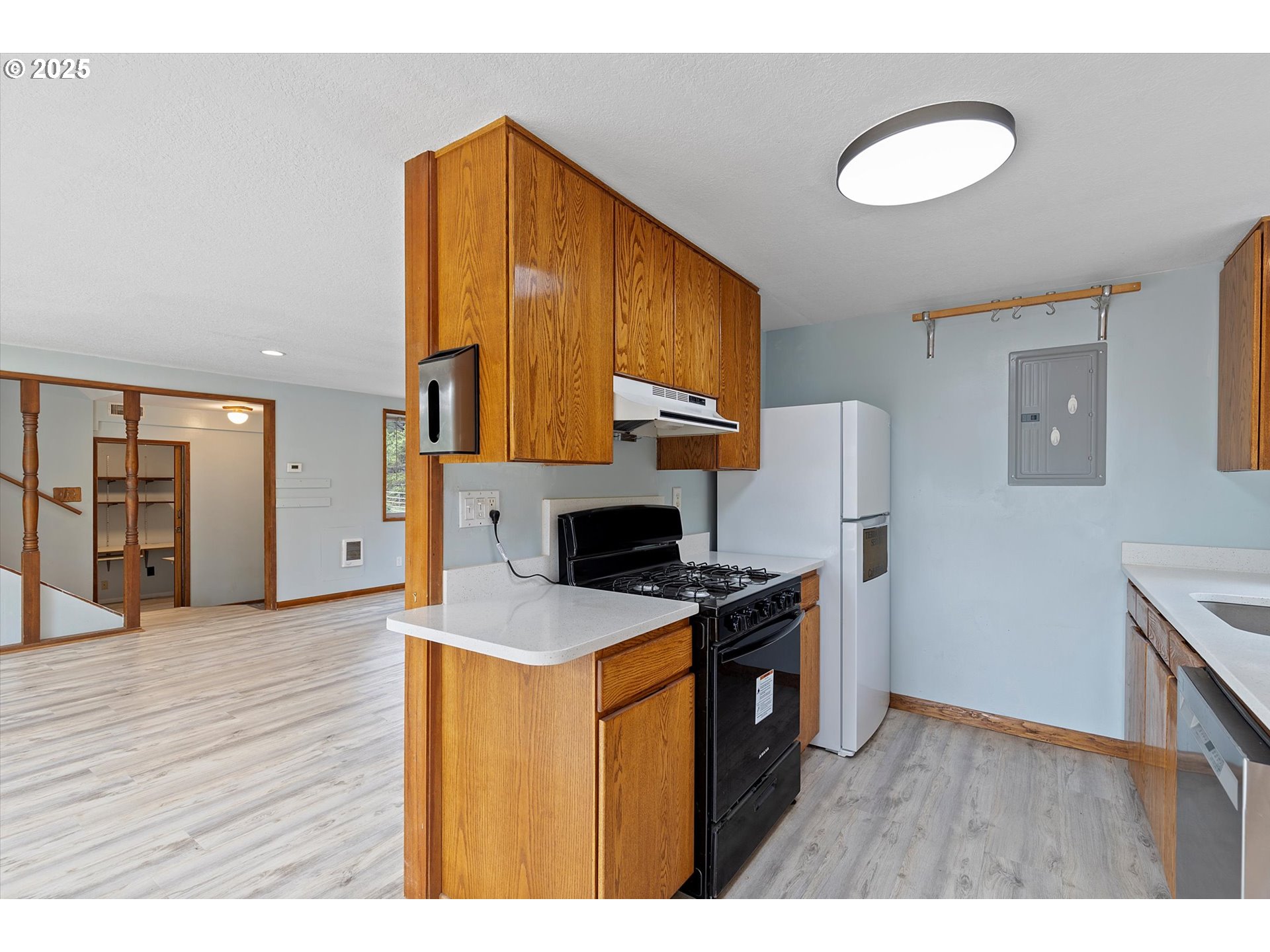 5825 Roma Avenue Cloverdale, OR 97112 - Photo 13 of 44 a kitchen with stainless steel appliances granite countertop a stove a sink and a refrigerator