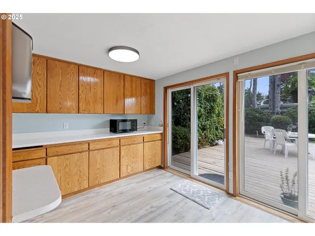 a kitchen with granite countertop a stove a sink and a refrigerator
