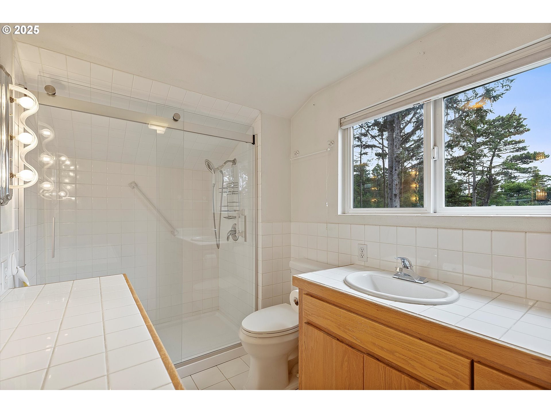 5825 Roma Avenue Cloverdale, OR 97112 - Photo 20 of 44 a bathroom with a granite countertop sink toilet a large mirror a shower and a bathtub