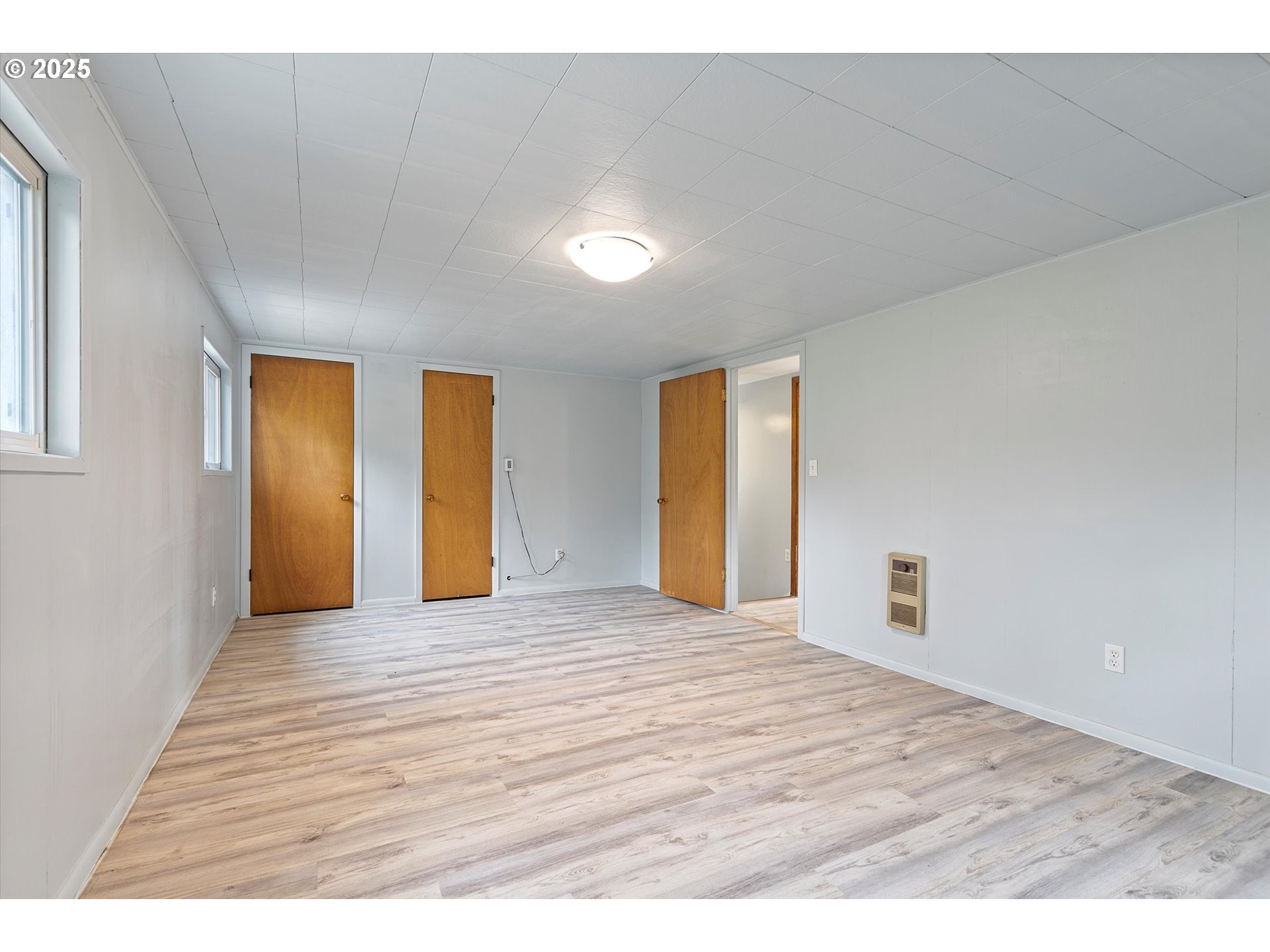 5825 Roma Avenue Cloverdale, OR 97112 - Photo 26 of 44 a view of an empty room with wooden floor and a window
