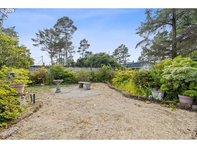 a backyard of a house with table and chairs