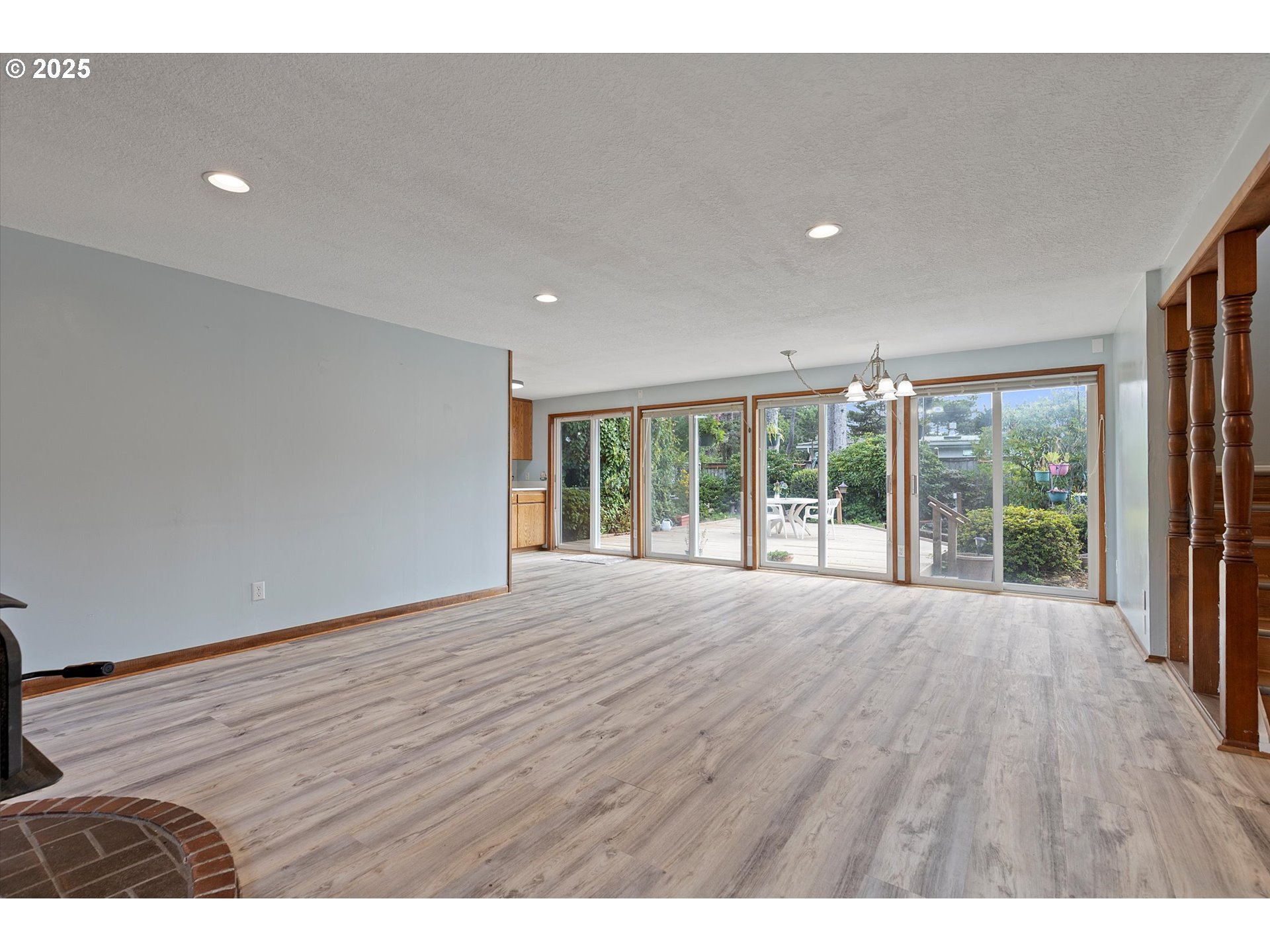 5825 Roma Avenue Cloverdale, OR 97112 - Photo 6 of 44 a view of an empty room with wooden floor and a window