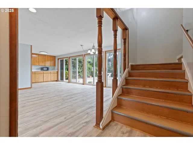 a view of an entryway with wooden floor