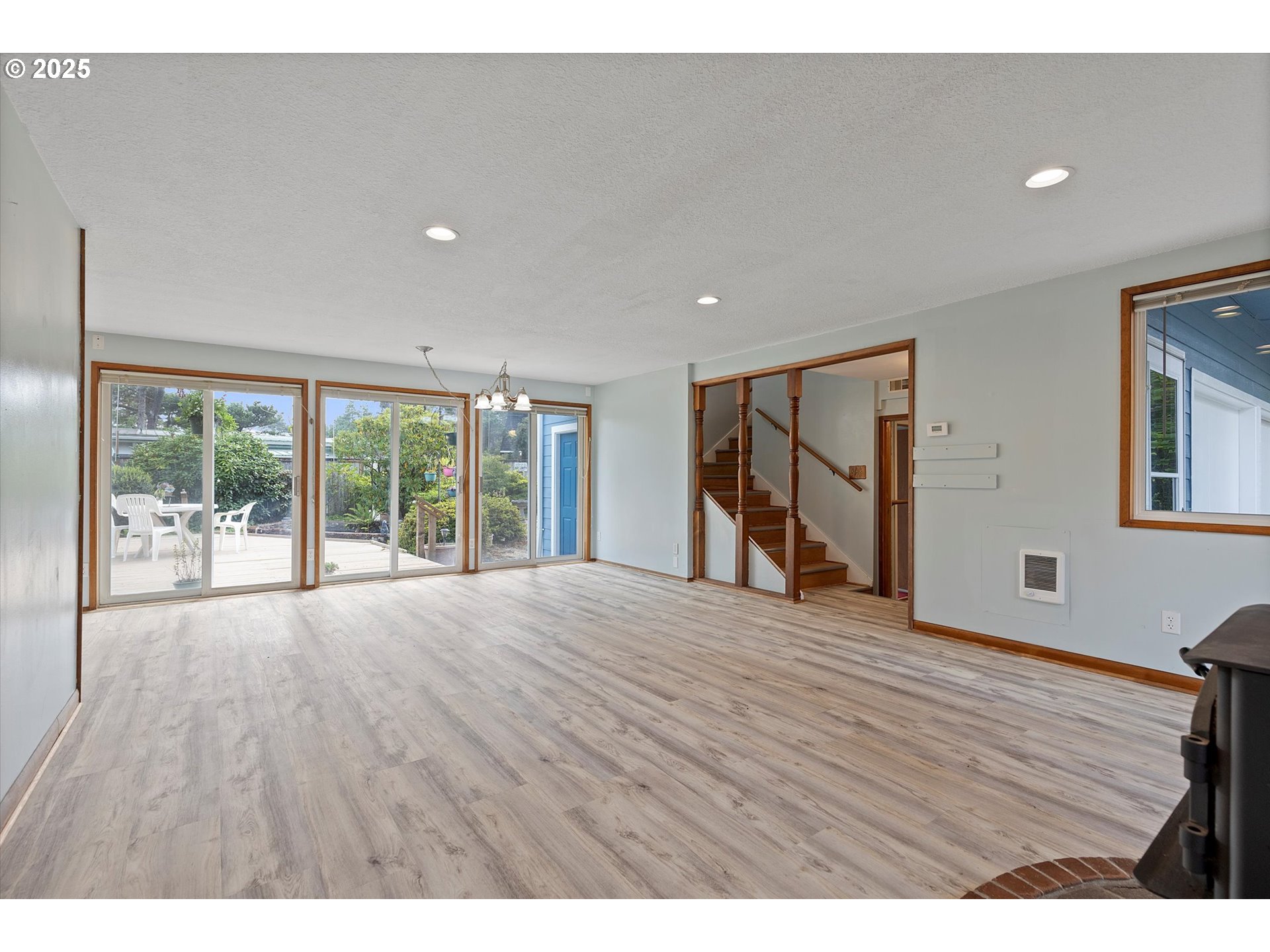 5825 Roma Avenue Cloverdale, OR 97112 - Photo 9 of 44 a view of an empty room with wooden floor and a window