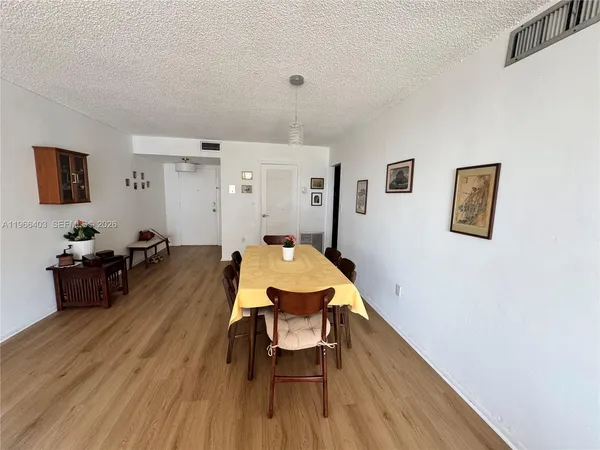 a very nice looking room with wooden floor and furniture