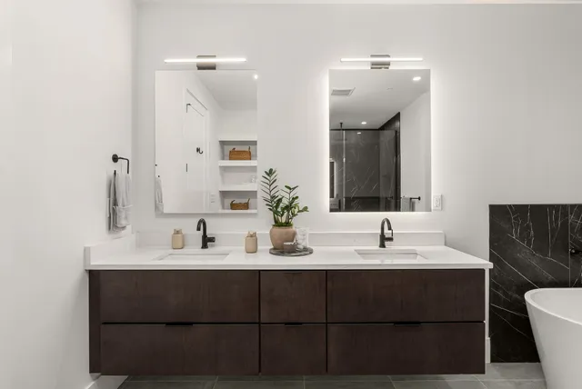 a living room with stainless steel appliances kitchen island granite countertop a sink and cabinets