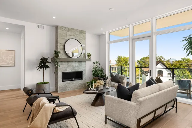 a very nice looking living room with a large window and furniture