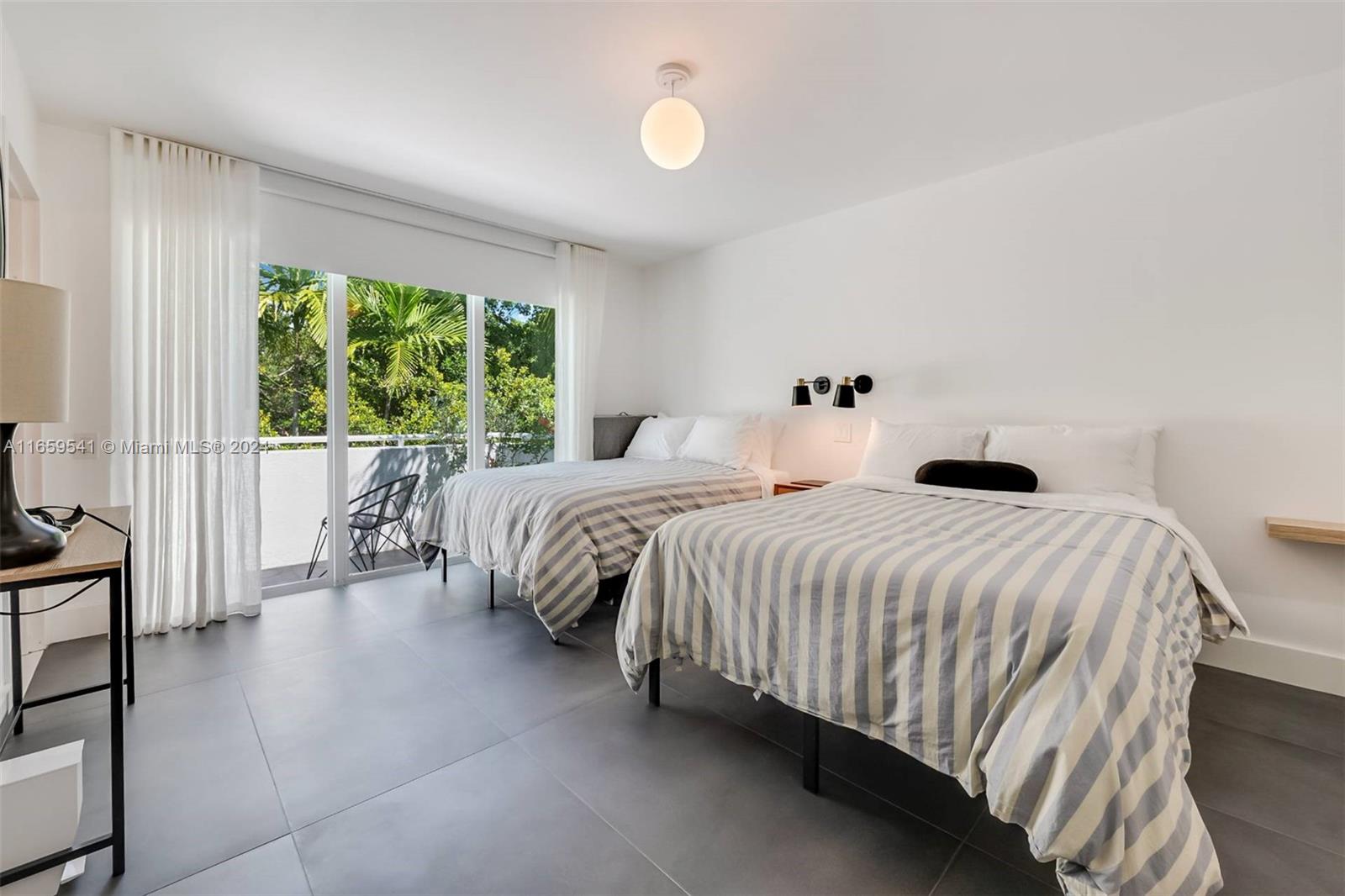 3266 Virginia Street, Unit B3 Miami, FL 33133 - Photo 14 of 24 a bedroom with a bed and a window