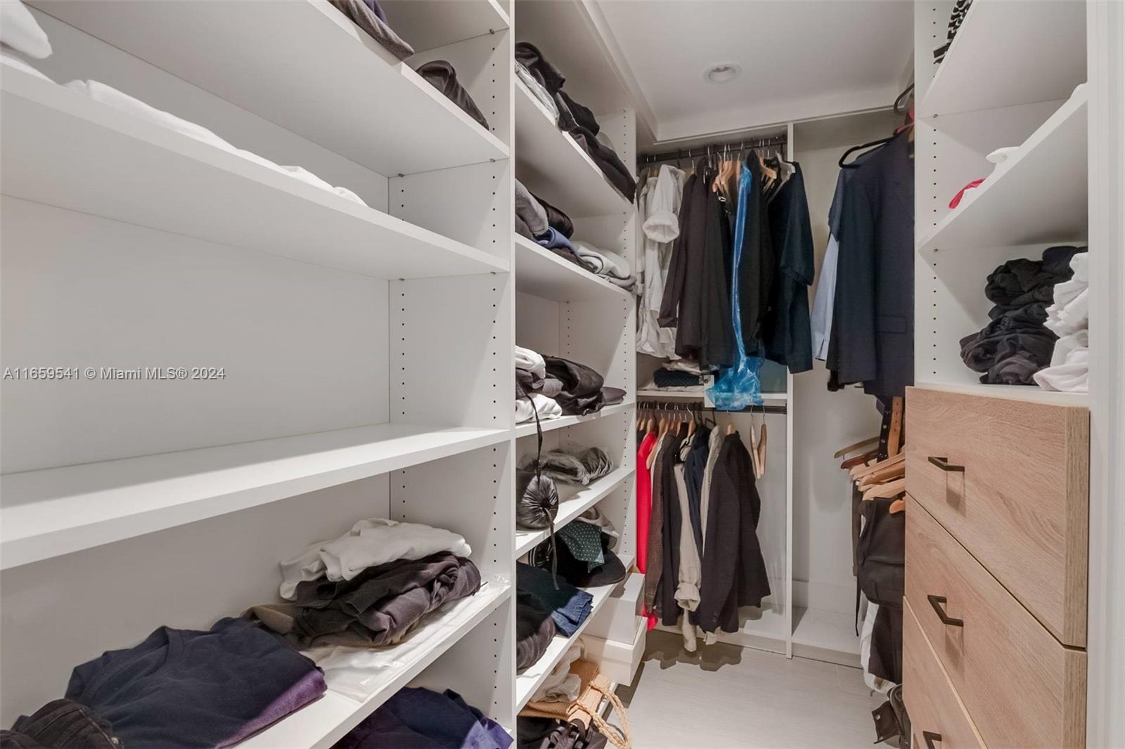 3266 Virginia Street, Unit B3 Miami, FL 33133 - Photo 17 of 24 a view of walk in closet with clothes and shoes