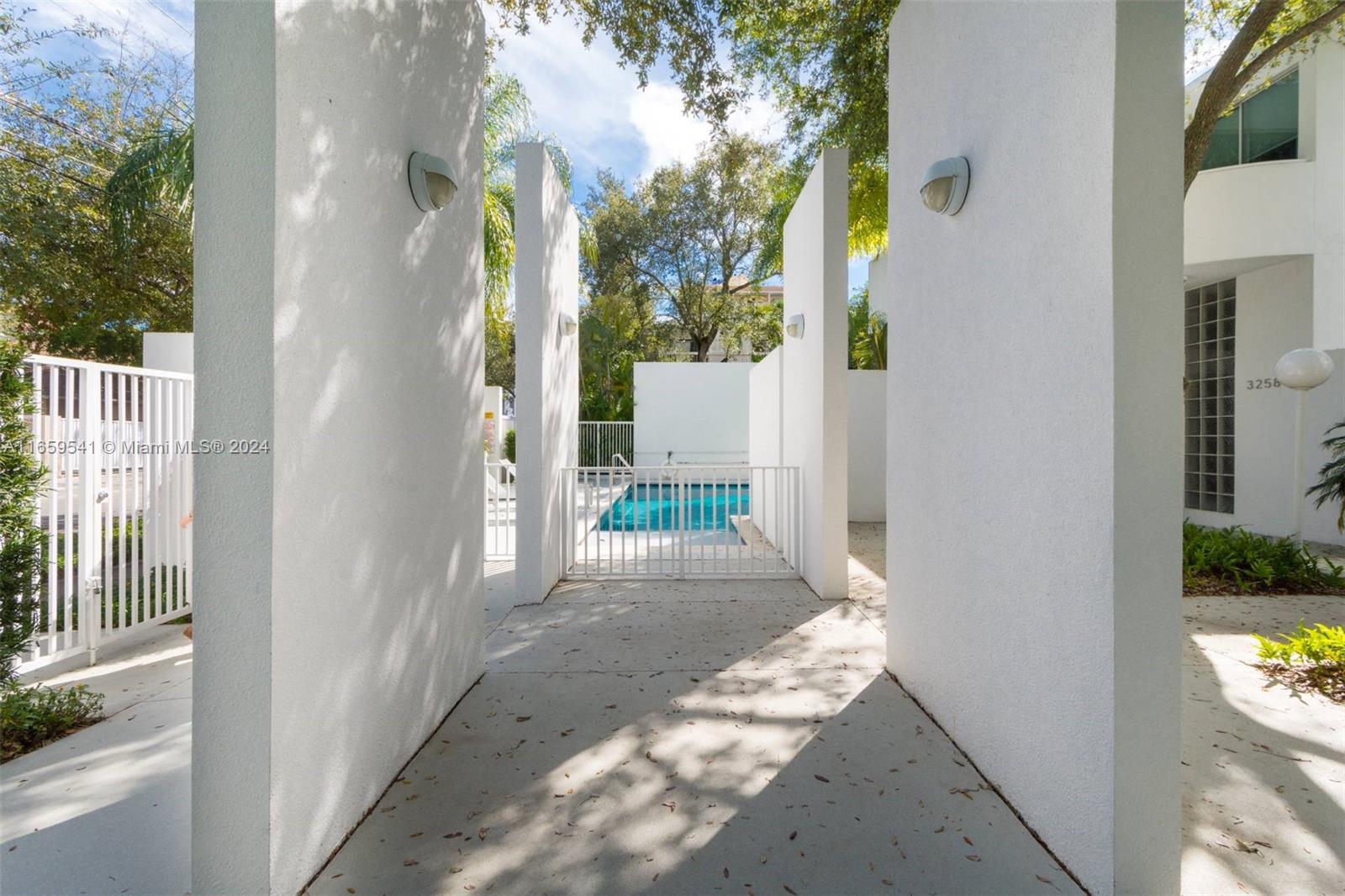 3266 Virginia Street, Unit B3 Miami, FL 33133 - Photo 20 of 24 a view of a door and chair in the balcony