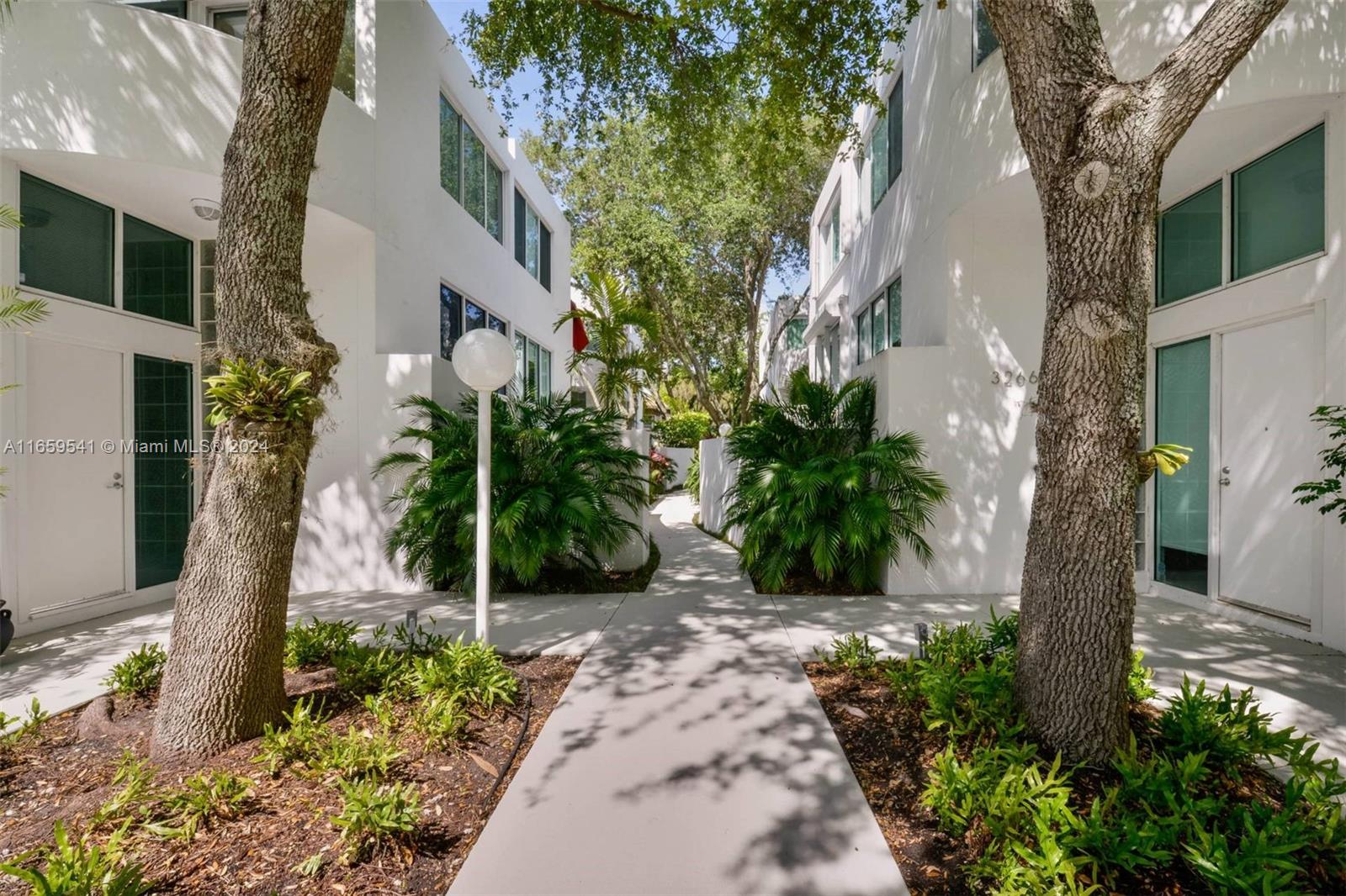 3266 Virginia Street, Unit B3 Miami, FL 33133 - Photo 22 of 24 a view of a pathway with a tree