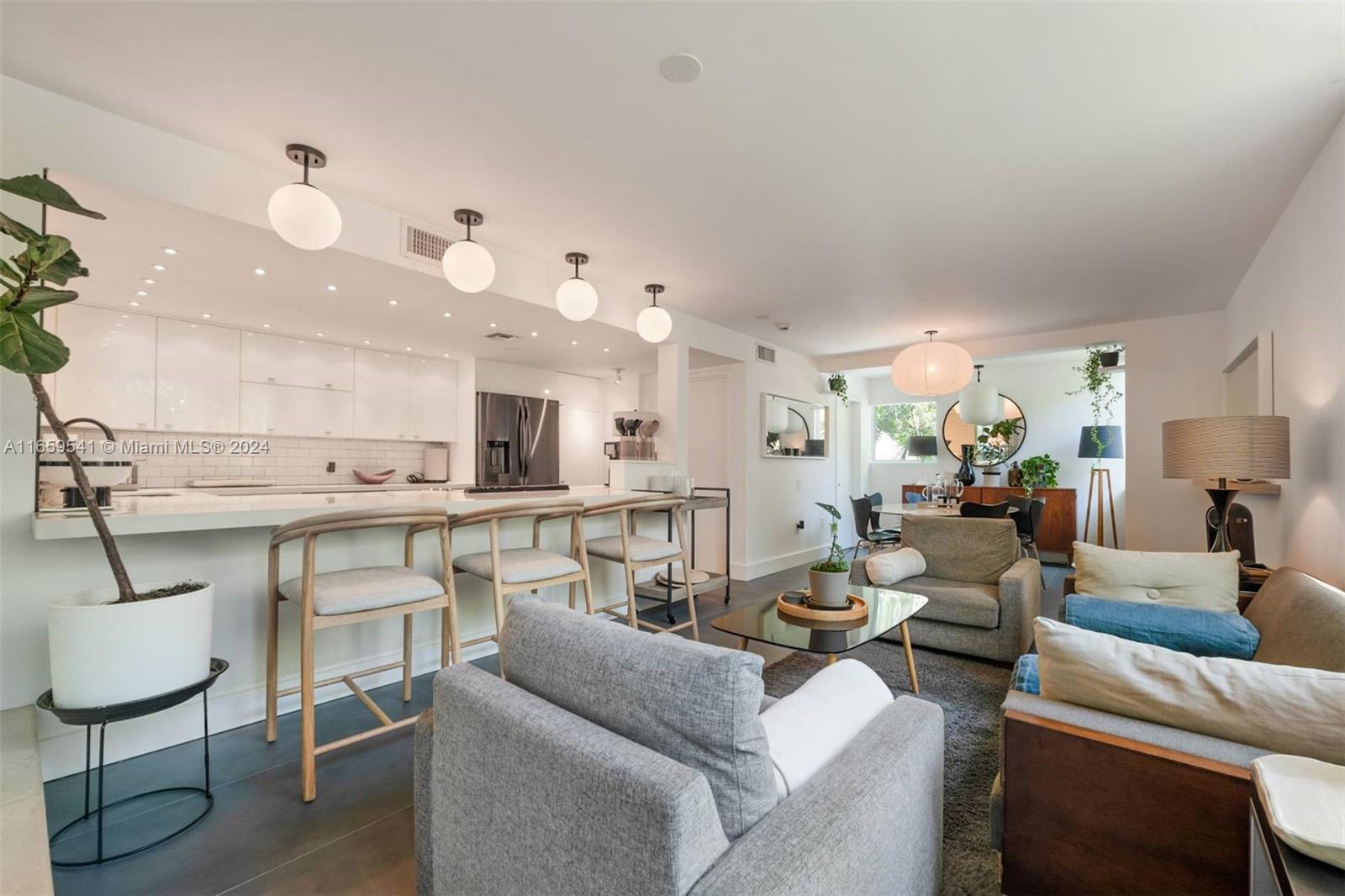 3266 Virginia Street, Unit B3 Miami, FL 33133 - Photo 6 of 24 a living room with furniture kitchen view and a chandelier