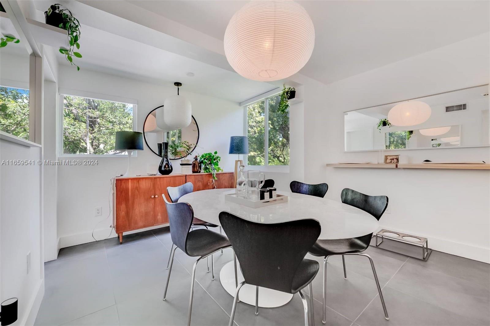 3266 Virginia Street, Unit B3 Miami, FL 33133 - Photo 8 of 24 a view of a dining room with furniture and a large window