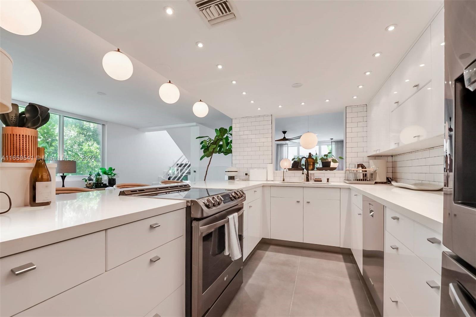 3266 Virginia Street, Unit B3 Miami, FL 33133 - Photo 9 of 24 a kitchen with a sink stove and cabinets