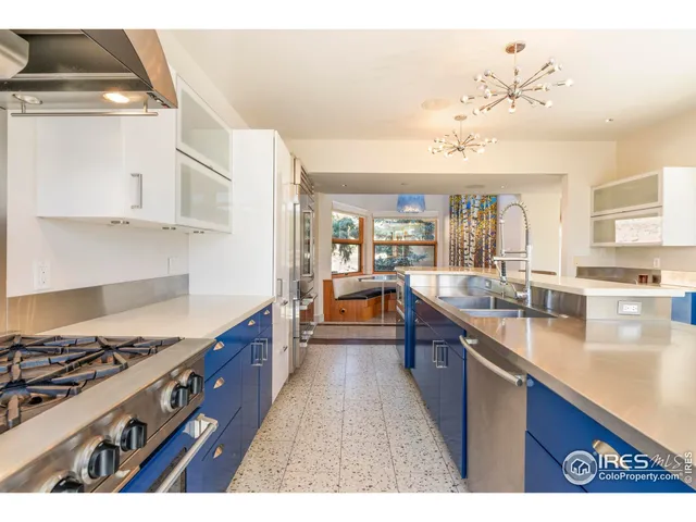 a kitchen with stainless steel appliances granite countertop a stove and a sink