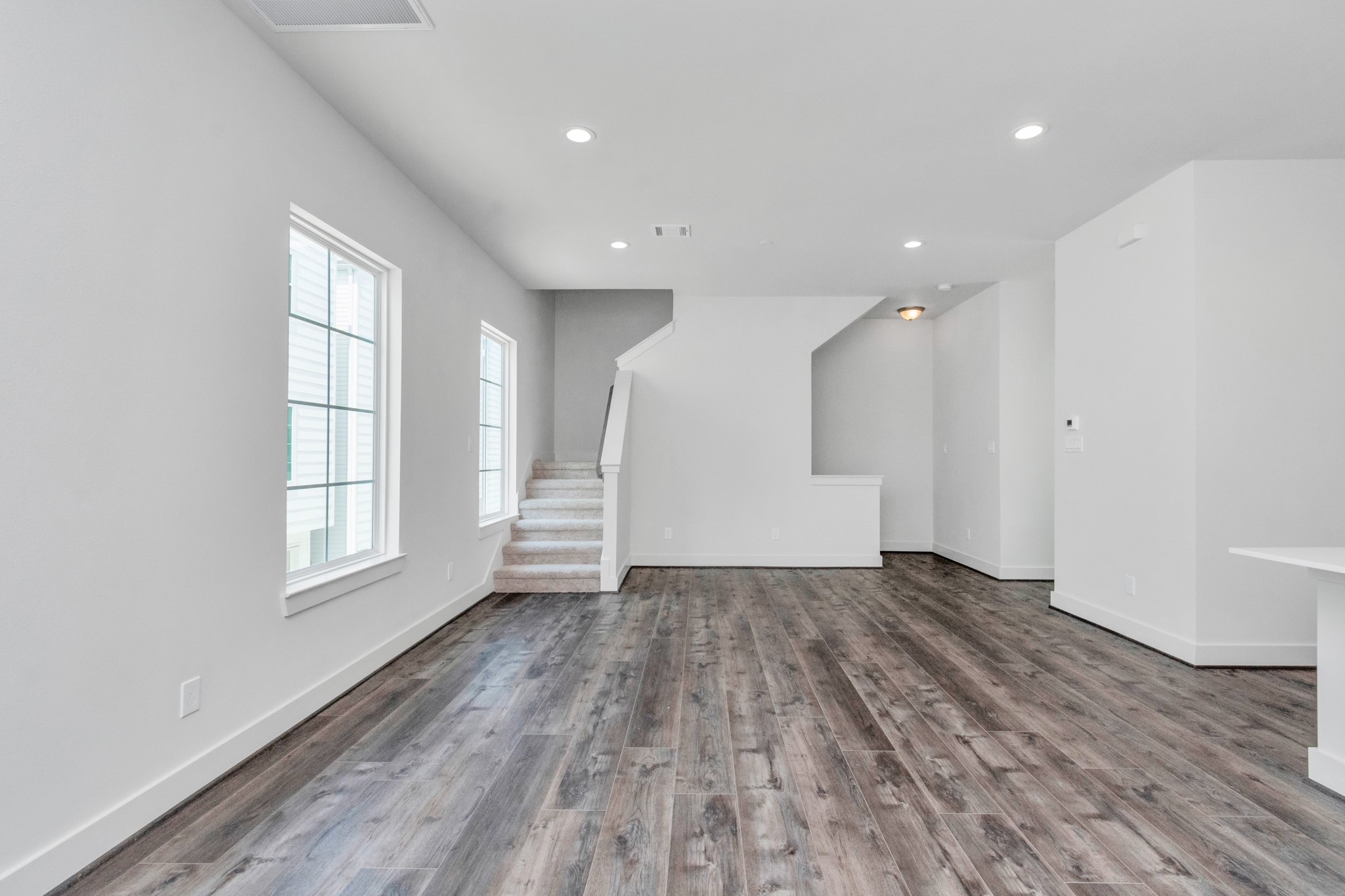 2011 East Bauer Drive Houston, TX 77080 - Photo 11 of 32 an empty room with wooden floor and windows