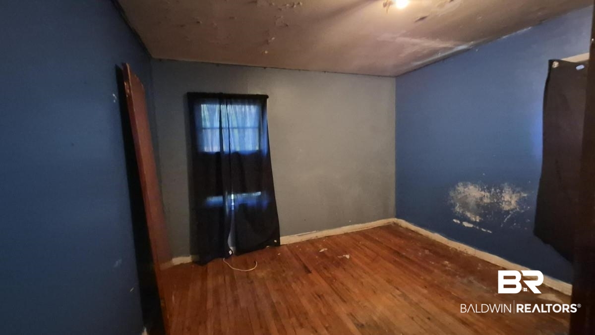 2207 Roberta Drive Mobile, AL 36617 - Photo 12 of 14 Empty room with baseboards and wood finished floors