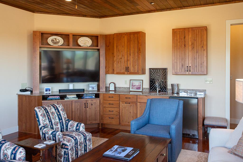 475 River Bend Road West Hunt, TX 78024 - Photo 23 of 87 a living room with furniture a flat screen tv and kitchen view
