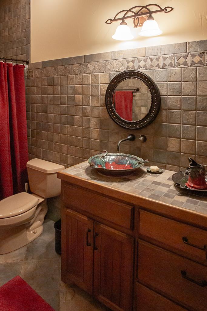 475 River Bend Road West Hunt, TX 78024 - Photo 30 of 87 a bathroom with a toilet a sink and a mirror