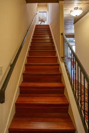 a view of a patio with dining table and chairs with wooden floor