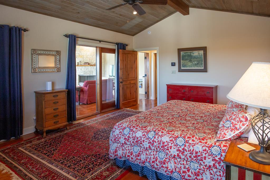 475 River Bend Road West Hunt, TX 78024 - Photo 35 of 87 a bedroom with a large bed and a dresser