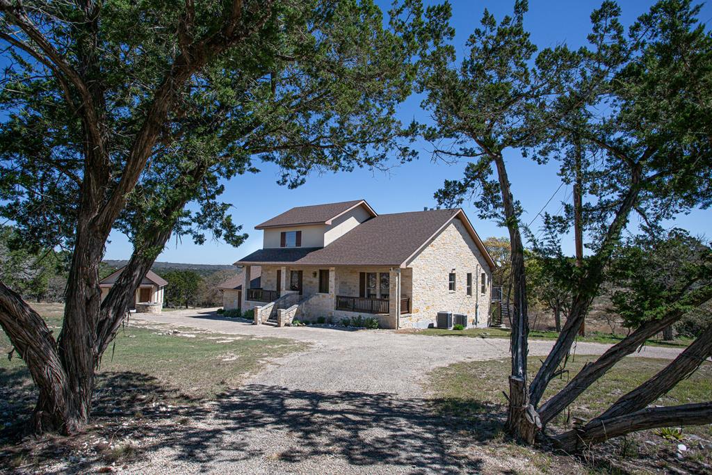 475 River Bend Road West Hunt, TX 78024 - Photo 78 of 87 a view of a white house with a large tree