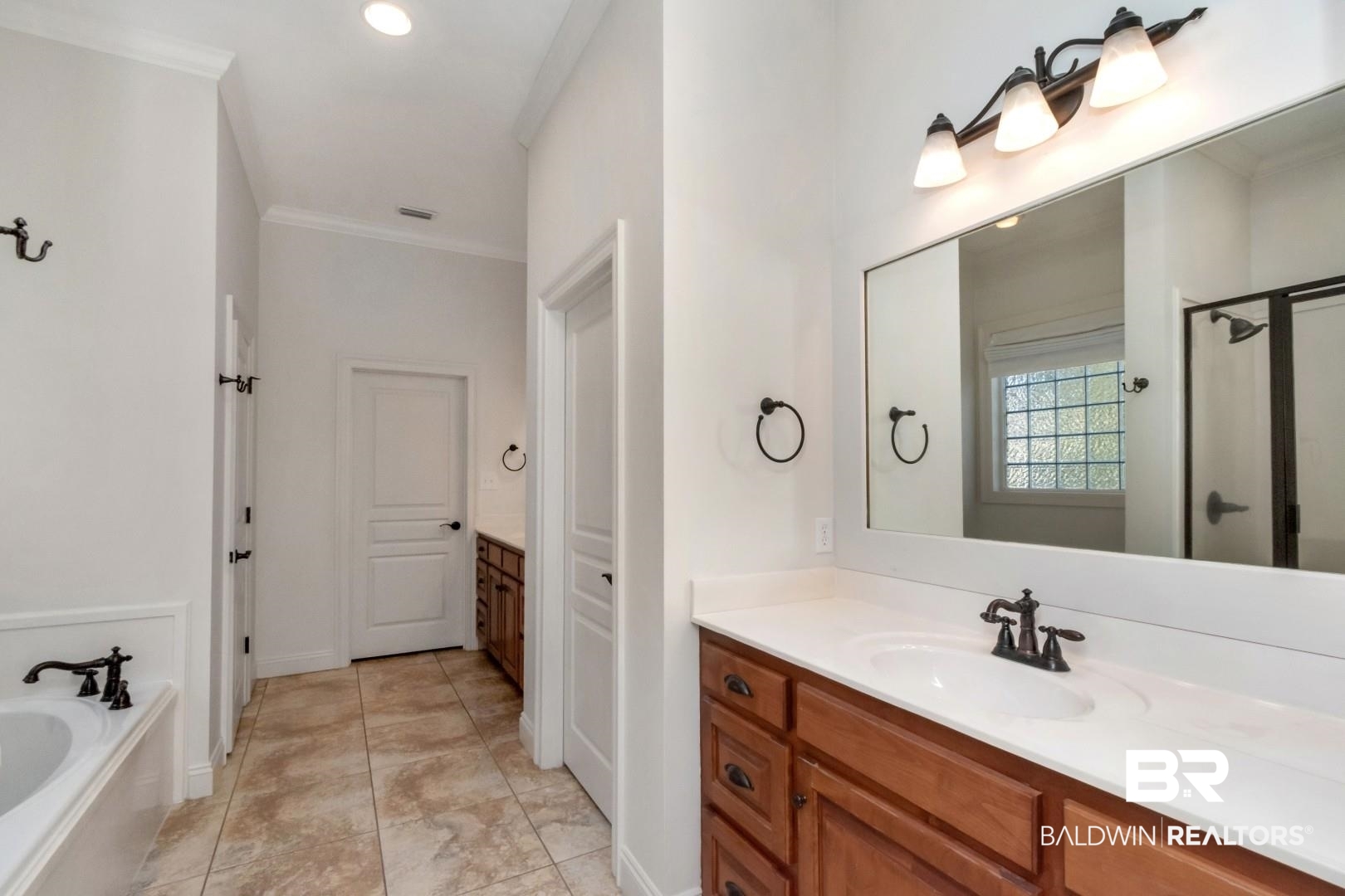 30585 Pine Court Daphne, AL 36527 - Photo 35 of 49 Full bath with vanity, crown molding, a garden tub, recessed lighting, and an enclosed shower