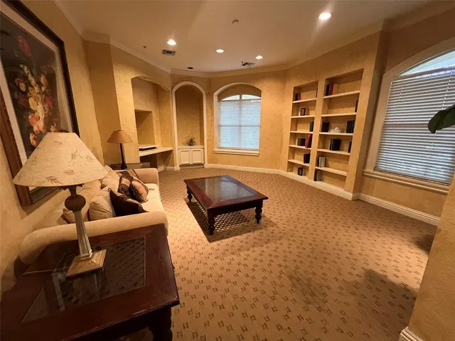 a lobby with furniture and a chandelier
