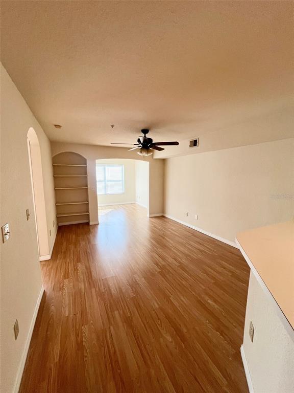 824 Camargo Way, Unit 211 Altamonte Springs, FL 32714 - Photo 3 of 24 wooden floor in an empty room with a window