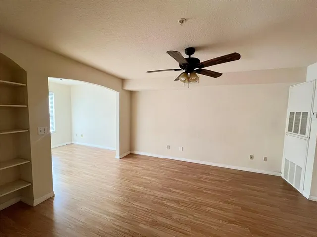 a kitchen with a sink a stove a refrigerator and white cabinets